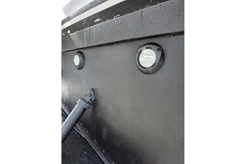  Yacht Photos Pics Close-up of 1993 McKinna 48 Pilothouse boat hull with portholes and fittings.