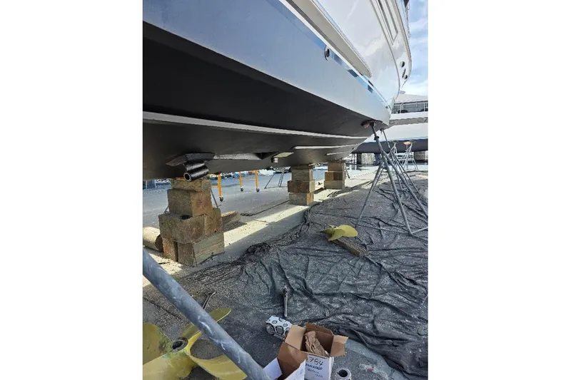  Yacht Photos Pics 1993 McKinna 48 Pilothouse yacht on blocks, undergoing maintenance in a shipyard.