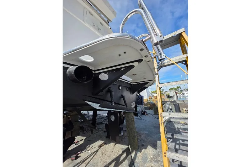  Yacht Photos Pics 1993 McKinna 48 Pilothouse yacht under maintenance, showing hull and ladder details.