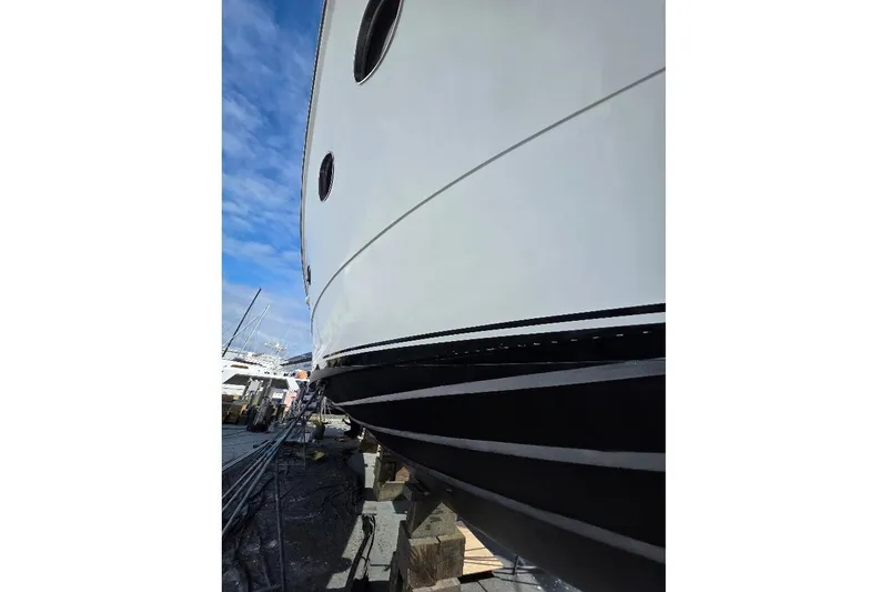  Yacht Photos Pics 1993 McKinna 48 Pilothouse yacht on dry dock, showcasing sleek hull design.