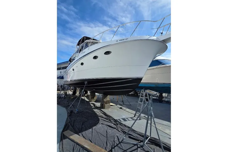  Yacht Photos Pics 1993 McKinna 48 Pilothouse yacht on dry dock, under clear blue sky.
