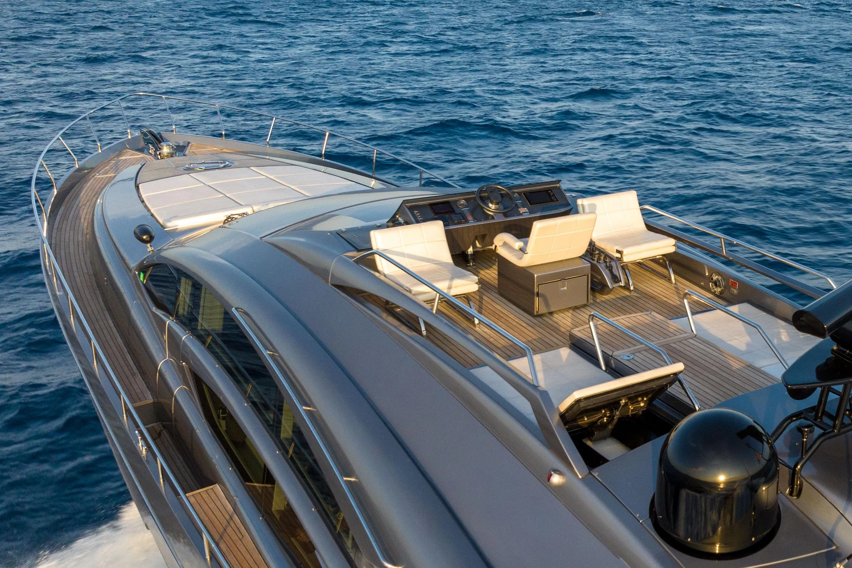 Luxurious 2017 Pershing 74 yacht cruising on open sea, showcasing sleek design and spacious deck.