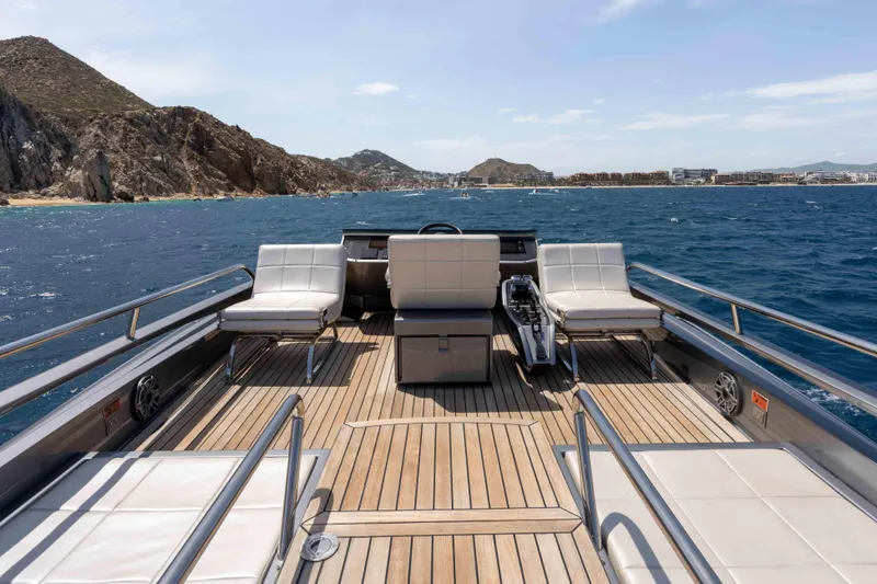 One Spin 2 Yacht Photos Pics Luxurious 2017 Pershing 74 yacht deck with seating, ocean view, and coastal backdrop.