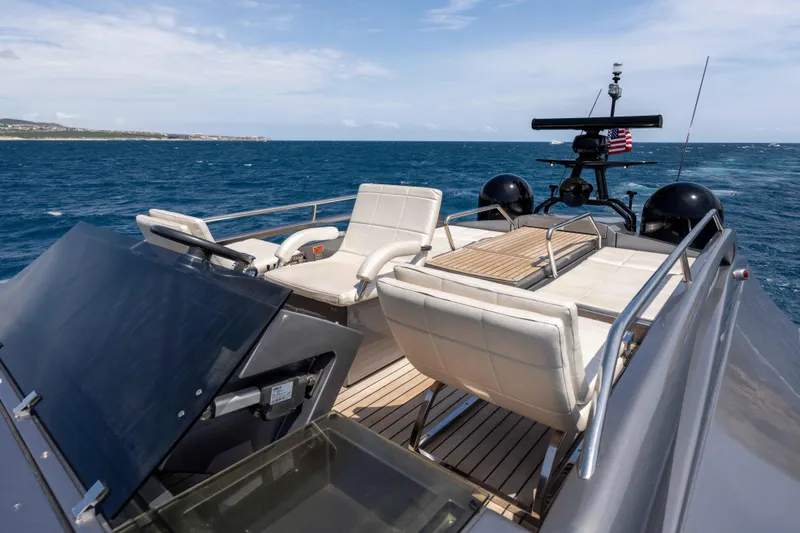 One Spin 2 Yacht Photos Pics Luxurious 2017 Pershing 74 yacht deck with seating, overlooking the ocean.