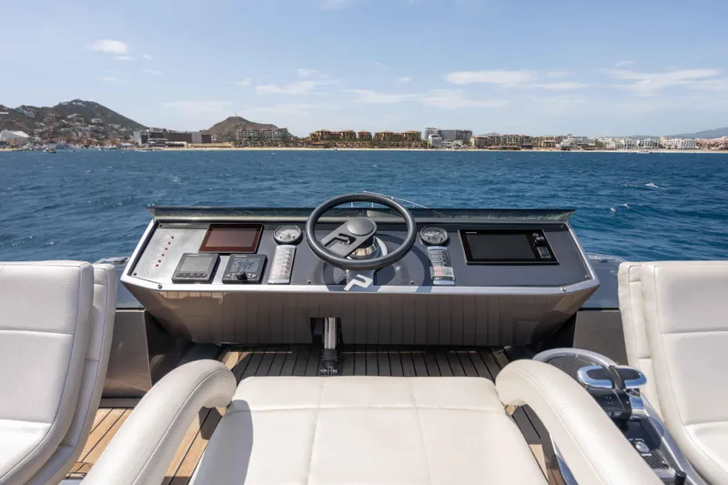 One Spin 2 Yacht Photos Pics Helm of 2017 Pershing 74 yacht with ocean and coastal view.