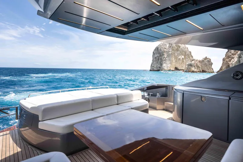 One Spin 2 Yacht Photos Pics Luxurious 2017 Pershing 74 yacht deck with ocean view and rocky coastline.