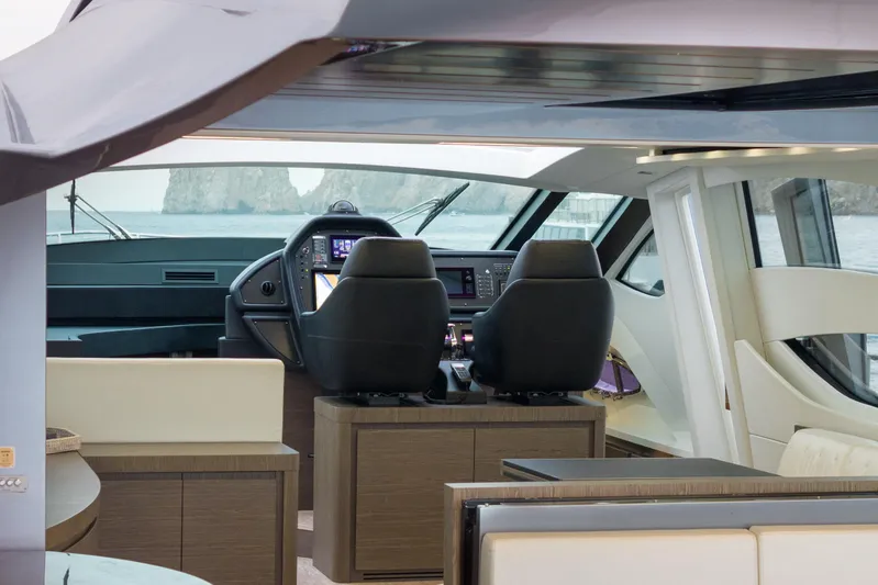 One Spin 2 Yacht Photos Pics Interior view of 2017 Pershing 74 yacht cockpit with modern controls and ocean backdrop.