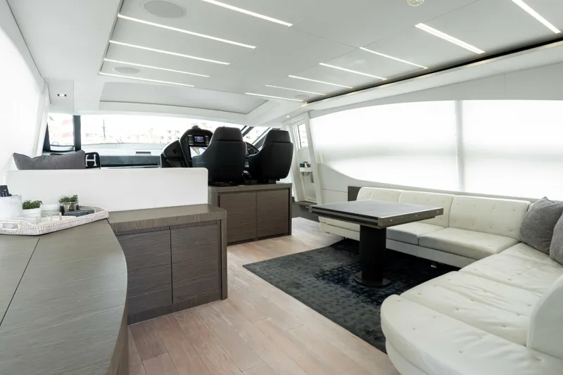 One Spin 2 Yacht Photos Pics Luxurious interior of a 2017 Pershing 74 yacht with modern seating and sleek design.