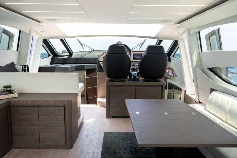 One Spin 2 Yacht Photos Pics Luxurious interior of a 2017 Pershing 74 yacht with modern helm and seating area.