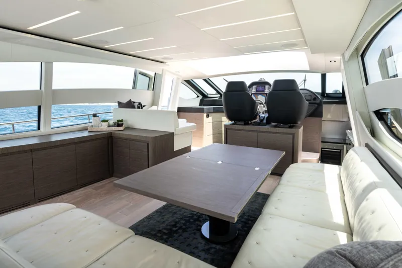 One Spin 2 Yacht Photos Pics Luxurious interior of 2017 Pershing 74 yacht with modern seating and panoramic windows.