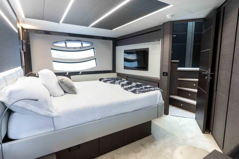 One Spin 2 Yacht Photos Pics Luxurious bedroom interior of 2017 Pershing 74 yacht with modern design and elegant furnishings.