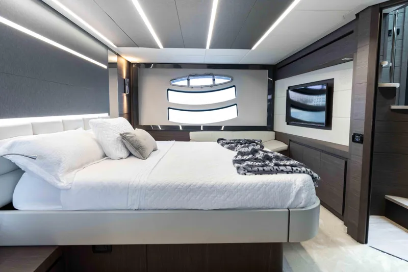 One Spin 2 Yacht Photos Pics Luxurious bedroom interior of 2017 Pershing 74 yacht with modern design and ambient lighting.