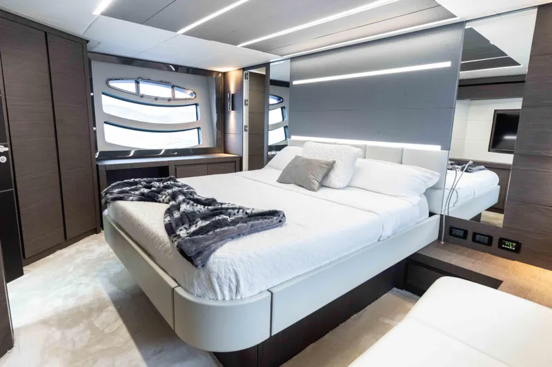 One Spin 2 Yacht Photos Pics Luxurious bedroom interior of 2017 Pershing 74 yacht with modern design and elegant furnishings.