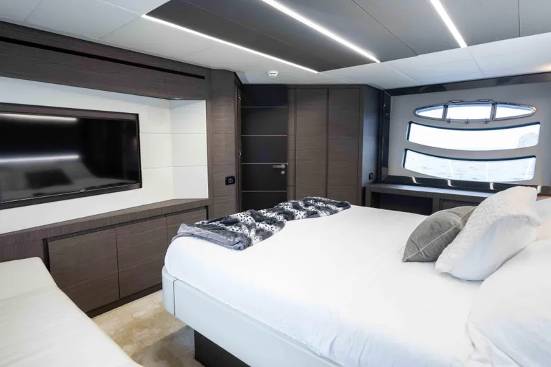 One Spin 2 Yacht Photos Pics Luxurious bedroom interior of 2017 Pershing 74 yacht with modern design and large window.
