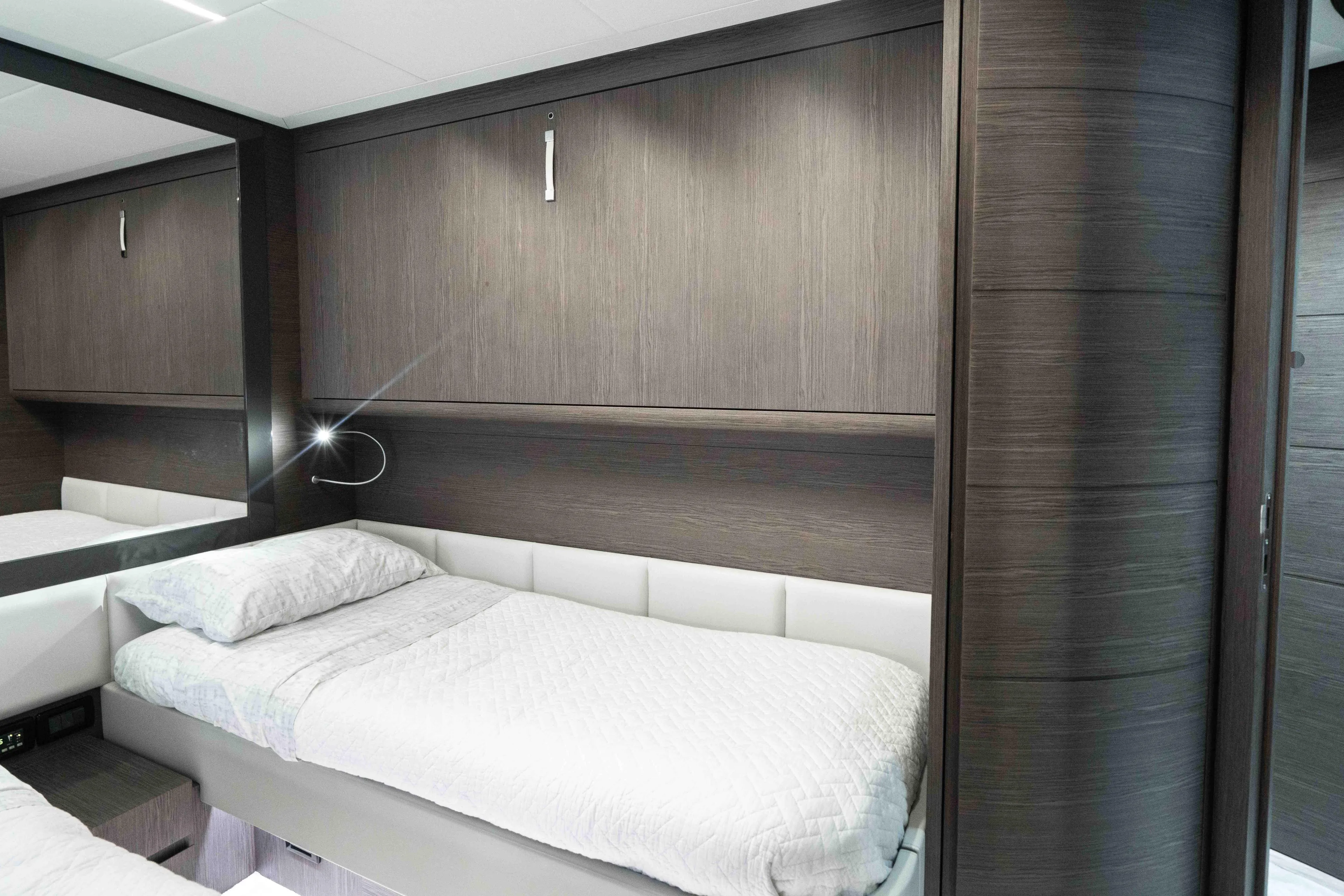 One Spin 2 Yacht Photos Pics Luxurious cabin interior of 2017 Pershing 74 yacht with modern design and cozy bedding.