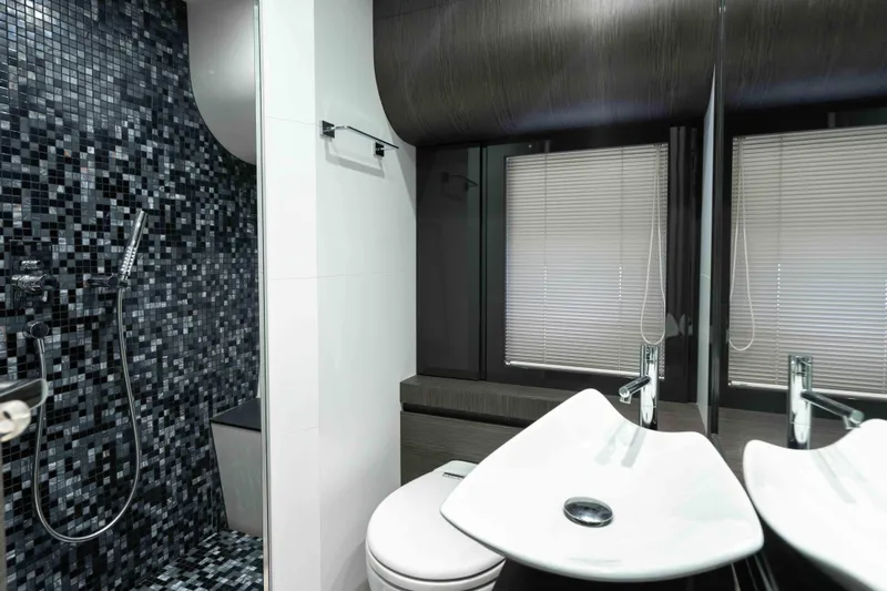 One Spin 2 Yacht Photos Pics Luxurious bathroom in 2017 Pershing 74 yacht with modern fixtures and mosaic tiles.