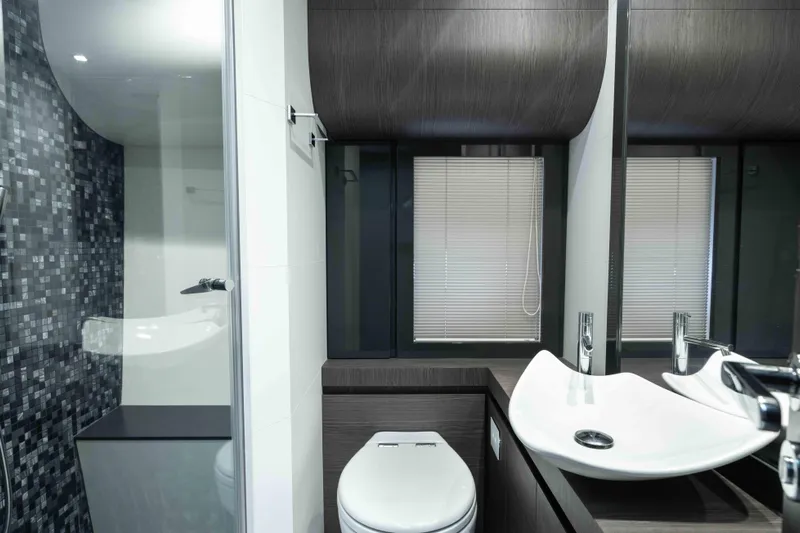 One Spin 2 Yacht Photos Pics Luxurious bathroom interior on 2017 Pershing 74 yacht, featuring modern sink and toilet design.