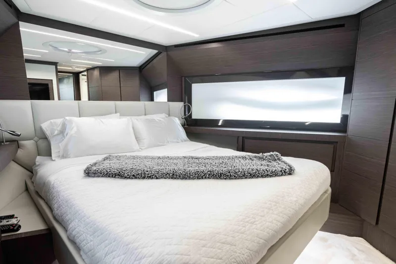 One Spin 2 Yacht Photos Pics Luxurious bedroom interior of 2017 Pershing 74 yacht with modern design and plush bedding.