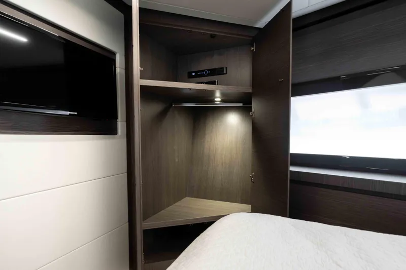 One Spin 2 Yacht Photos Pics Luxurious interior of 2017 Pershing 74 yacht with modern cabinetry and TV.