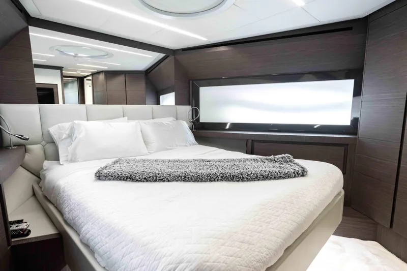 One Spin 2 Yacht Photos Pics Luxurious bedroom interior of 2017 Pershing 74 yacht with modern design and elegant bedding.
