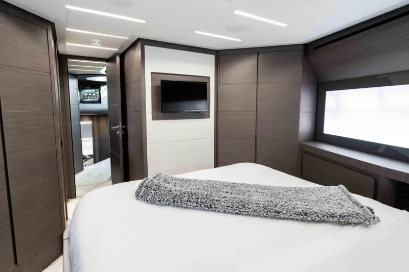 One Spin 2 Yacht Photos Pics Luxurious interior of 2017 Pershing 74 yacht bedroom with modern design and cozy bedding.