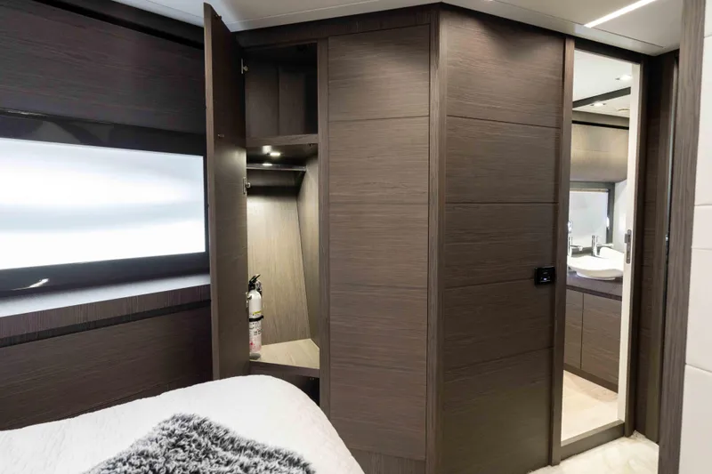 One Spin 2 Yacht Photos Pics Luxurious interior of 2017 Pershing 74 yacht with modern wood paneling and sleek design.