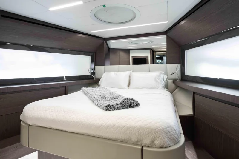 One Spin 2 Yacht Photos Pics Luxurious bedroom interior of 2017 Pershing 74 yacht with modern design and cozy bedding.