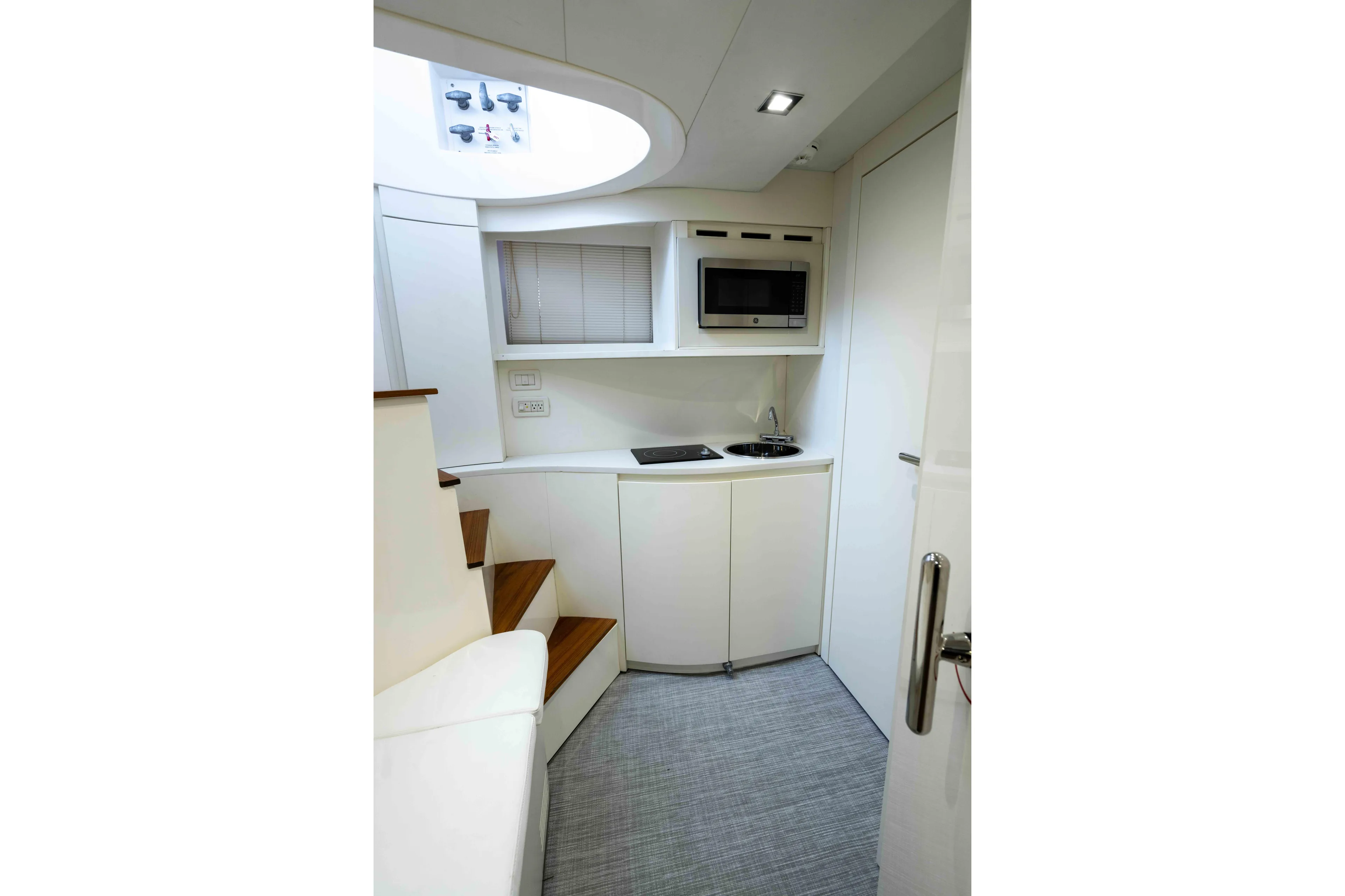 One Spin 2 Yacht Photos Pics Modern kitchen interior of 2017 Pershing 74 yacht with sleek design and compact amenities.