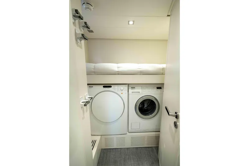 One Spin 2 Yacht Photos Pics Laundry area with washer and dryer on 2017 Pershing 74 yacht.