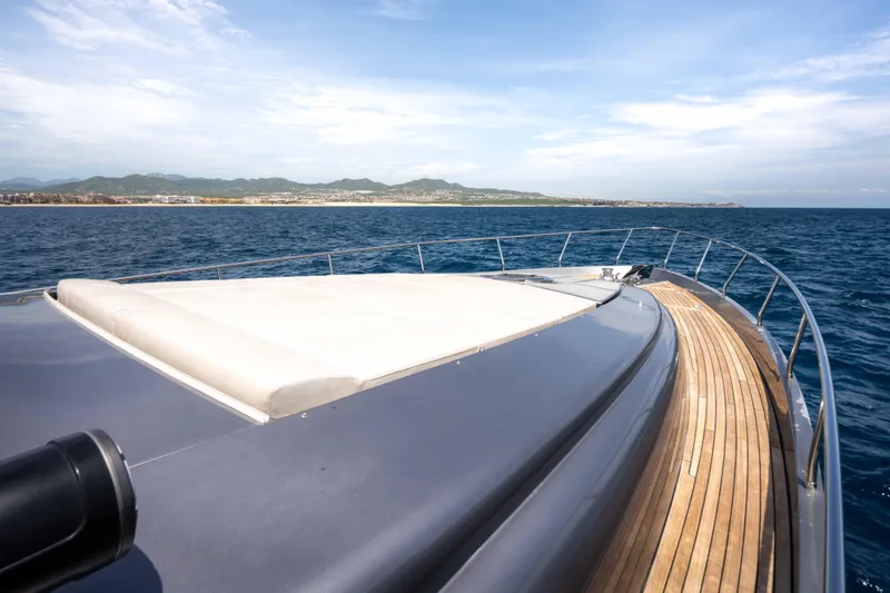 One Spin 2 Yacht Photos Pics Luxury 2017 Pershing 74 yacht cruising on open sea with scenic coastline view.