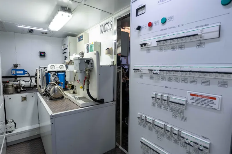 One Spin 2 Yacht Photos Pics Engine room of a 2017 Pershing 74 yacht with control panels and machinery.
