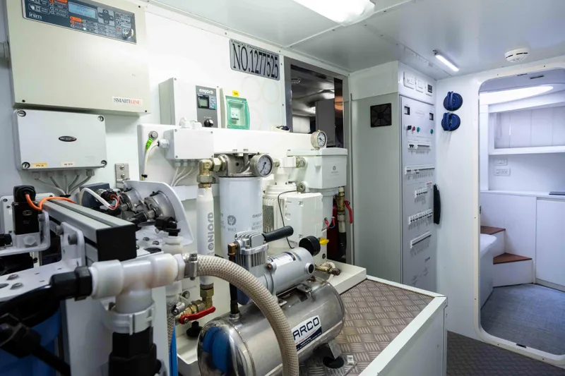 One Spin 2 Yacht Photos Pics Engine room of a 2017 Pershing 74 yacht, showcasing advanced machinery and control panels.