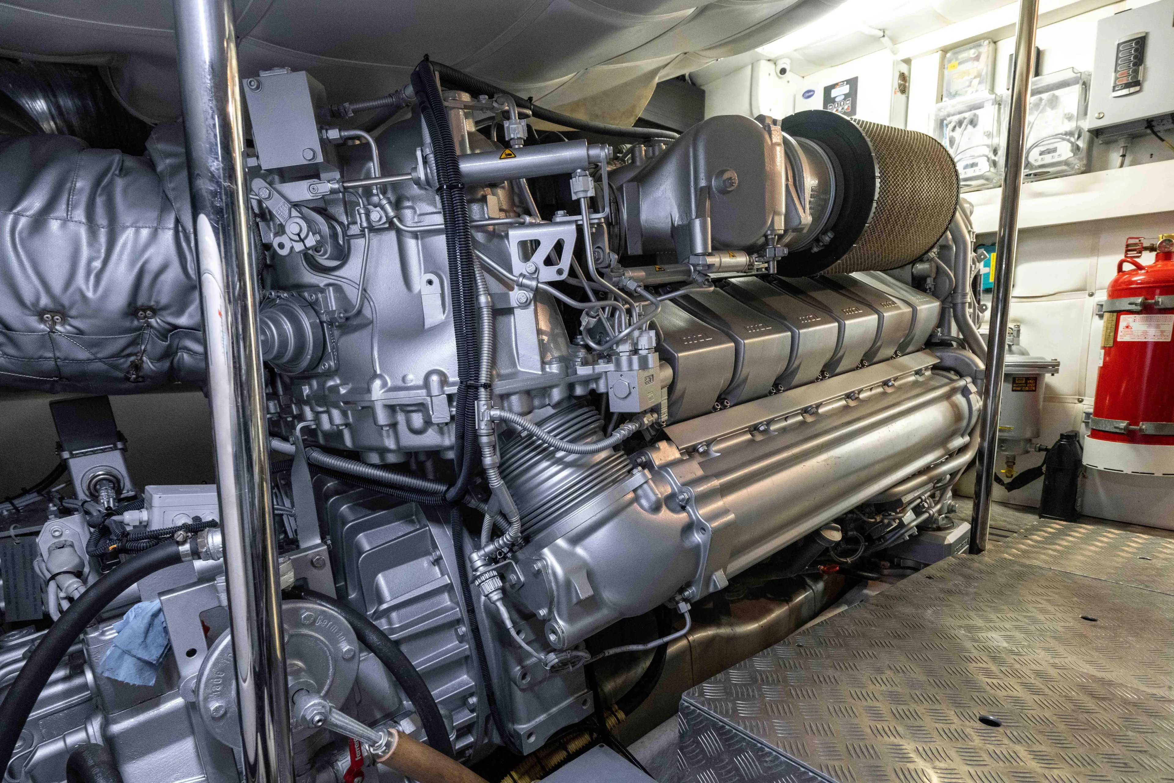 One Spin 2 Yacht Photos Pics Engine room of 2017 Pershing 74 yacht, showcasing detailed machinery and components.