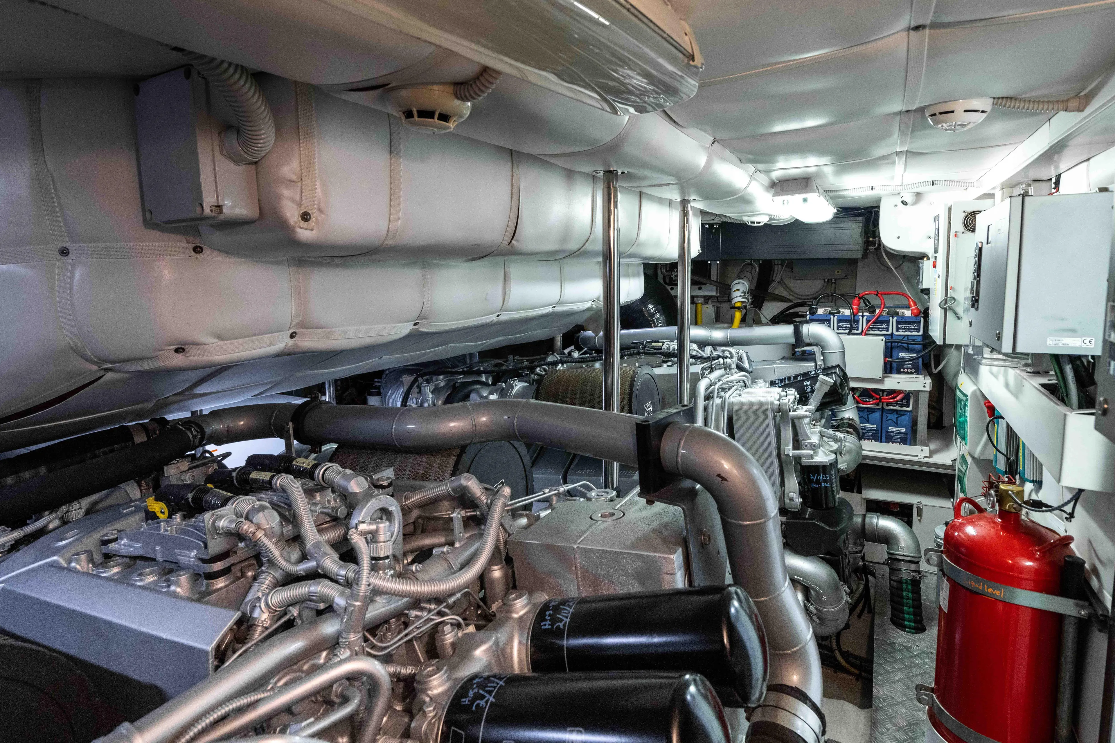 One Spin 2 Yacht Photos Pics Engine room of a 2017 Pershing 74 yacht, showcasing complex machinery and systems.