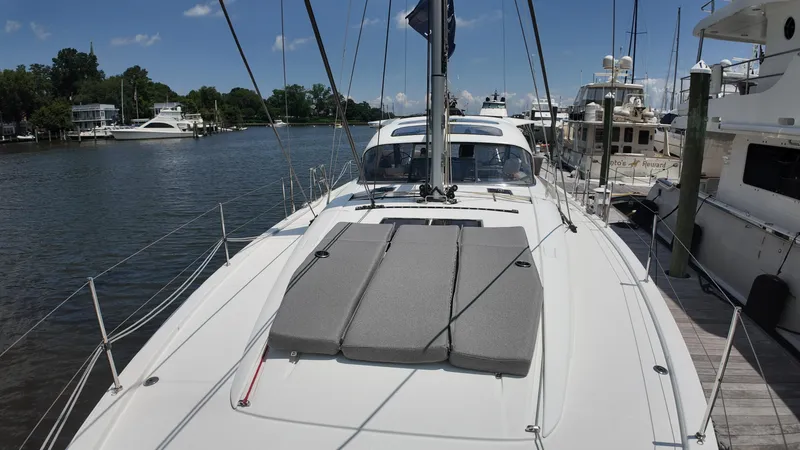  Yacht Photos Pics 2024 Jeanneau 55 yacht docked at marina, featuring sleek deck design and modern amenities.