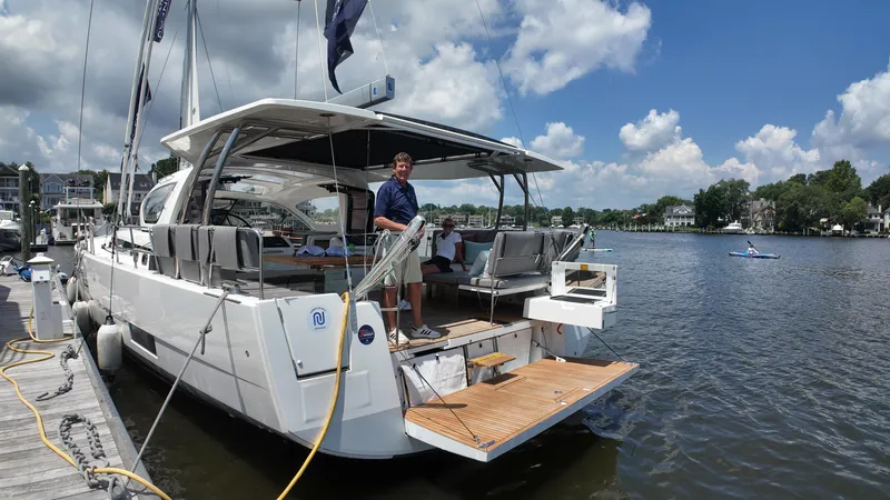  Yacht Photos Pics 2024 Jeanneau 55 yacht docked, featuring spacious deck and modern design.