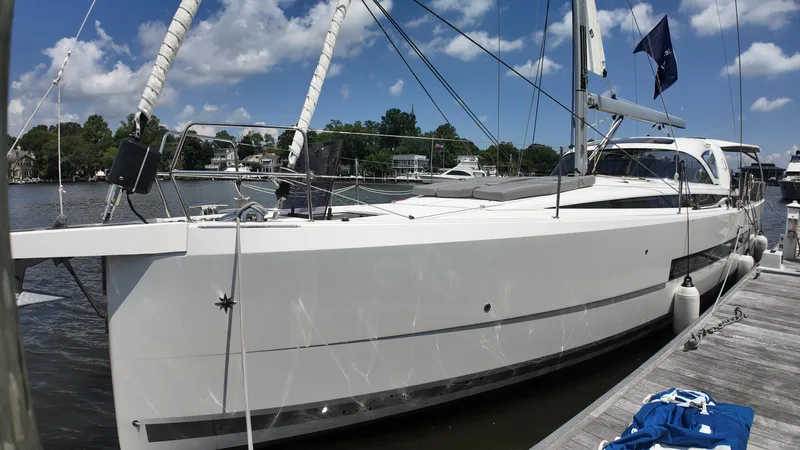  Yacht Photos Pics 2024 Jeanneau 55 yacht docked, showcasing sleek design and modern features under a clear blue sky.