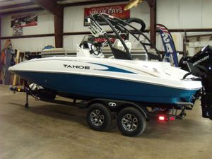 2025 Tahoe 2150 CC boat on trailer in indoor showroom.