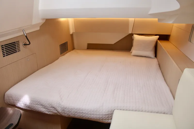  Yacht Photos Pics 2024 Jeanneau 55 yacht interior cabin with bed and pillow.