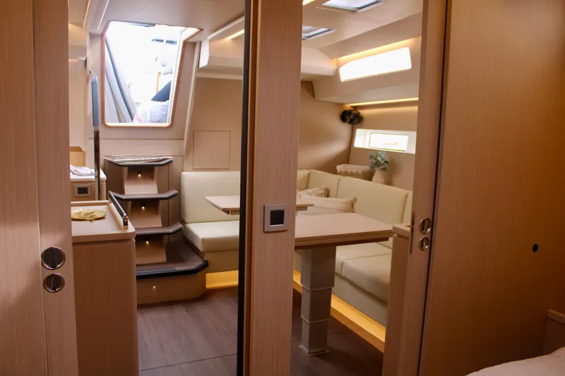  Yacht Photos Pics 2024 Jeanneau 55 interior with modern dining area and staircase.