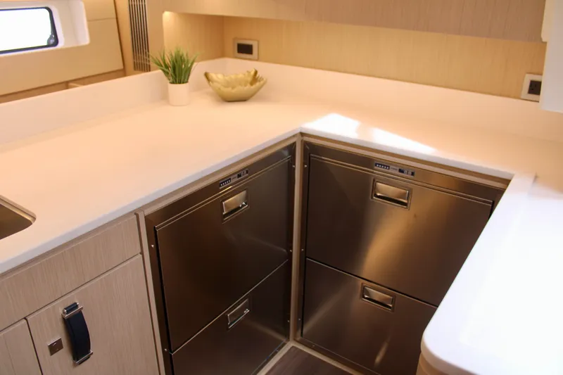  Yacht Photos Pics Modern kitchen area in 2024 Jeanneau 55 yacht with stainless steel appliances.