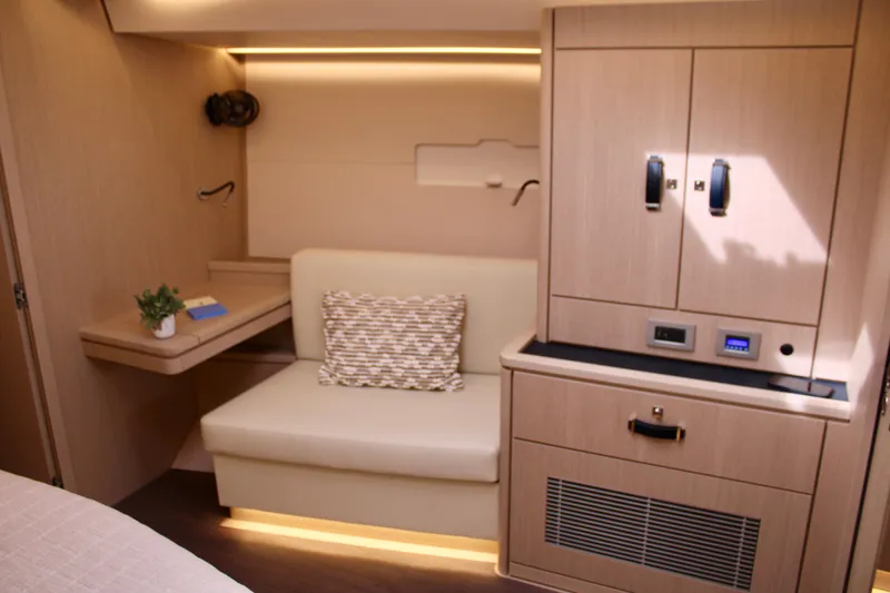  Yacht Photos Pics Luxurious interior of 2024 Jeanneau 55 yacht with modern seating and cabinetry.