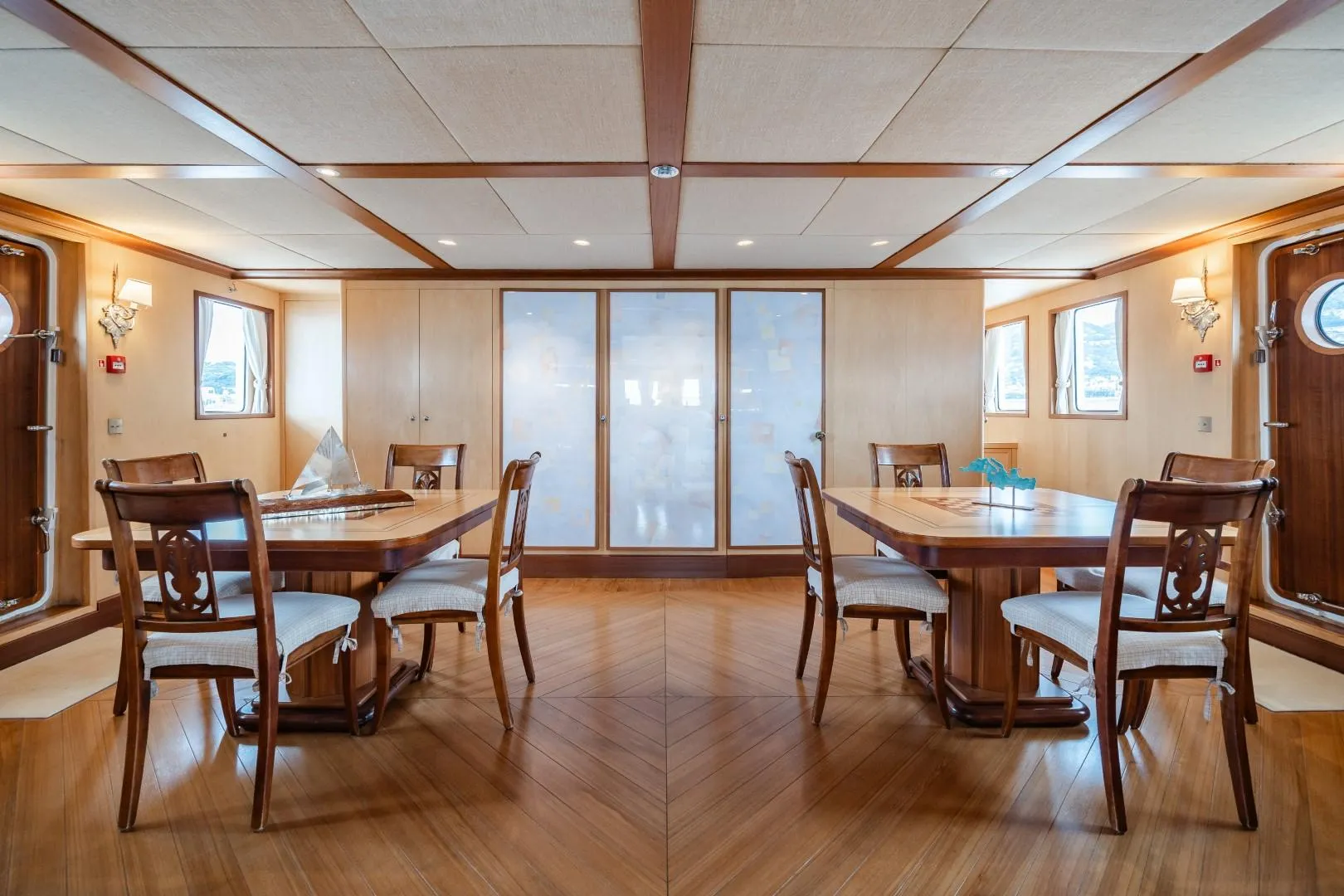 Luxurious yacht dining room with elegant wooden furniture, custom design, 1990 model.