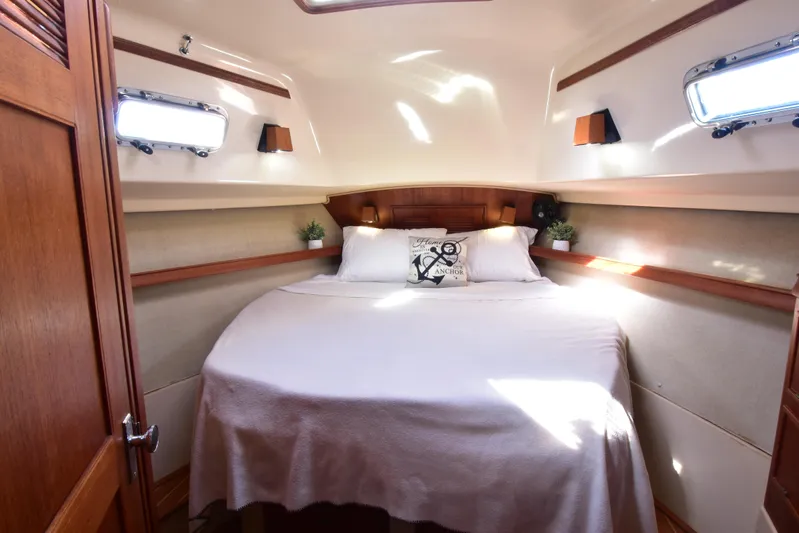 Aftia Yacht Photos Pics Cozy cabin interior of 1999 Island Packet 380 sailboat with double bed and portholes.