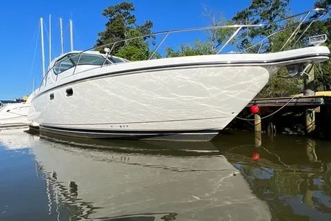  Yacht Photos Pics 2007 Tiara Yachts 4300 Sovran docked on calm water, clear blue sky.