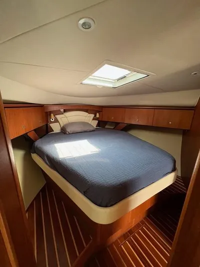  Yacht Photos Pics Luxurious cabin interior of 2007 Tiara Yachts 4300 Sovran with cozy bed and wooden accents.