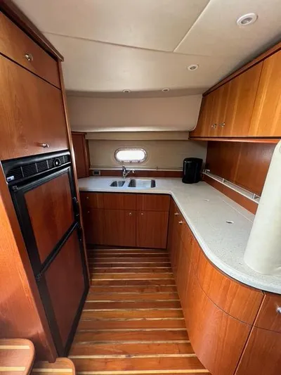  Yacht Photos Pics 2007 Tiara Yachts 4300 Sovran kitchen with wood cabinetry and modern appliances.
