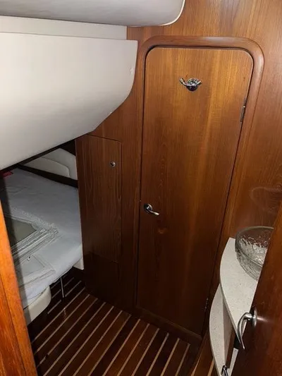  Yacht Photos Pics 2007 Tiara Yachts 4300 Sovran cabin interior with wooden door and flooring.