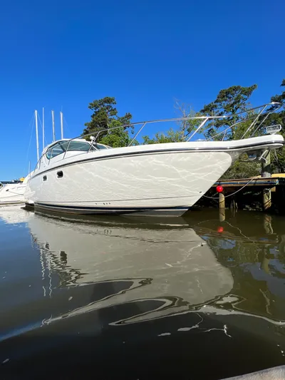  Yacht Photos Pics 2007 Tiara Yachts 4300 Sovran docked on calm water under clear blue sky.