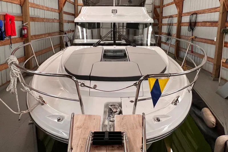  Yacht Photos Pics 2021 Jeanneau NC 1095 FLY boat docked in a covered marina.